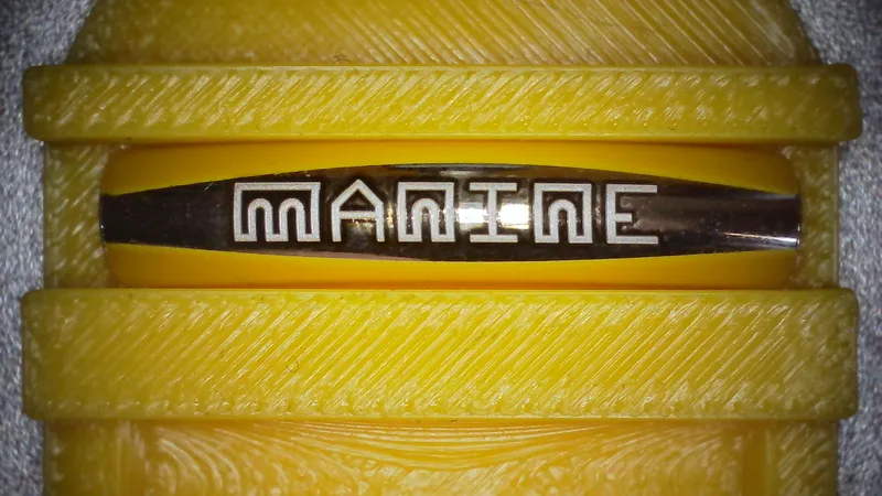 Logo Manine gravé sur un tube courbe avec argenture, maintenu dans son gabarit